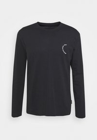 Black long-sleeve t-shirt made of cotton. Features a round neckline and a small white printed logo on the left side. Simple design.