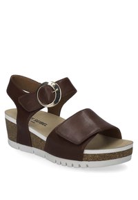 Hnědá kožená sandál s širokým páskem a kulatým stříbrným kováním. Obsahuje bílou gumovou podrážku s texturovaným korkovým detailem.
