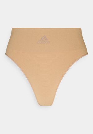 Beige high-waisted underwear made of textured fabric. Features an embossed adidas logo on the front and smooth edges.