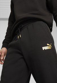Puma MINIMAL GOLD JOGGING - Pantalones deportivos - black