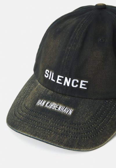 Black denim cap featuring white embroidered text "SILENCE" on the front and "HAN KJØBENHAVN" on the side, with a distressed finish.