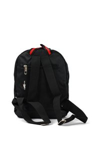 Black fabric backpack with red accents, zipper closure, adjustable black straps, and mesh texture. Features a small logo on the side.