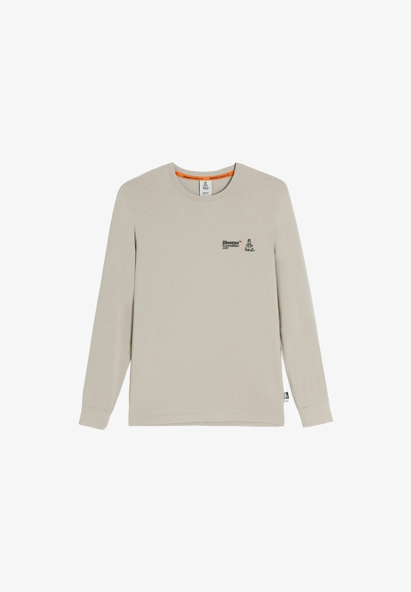 Jasno beżowa, długosleeve koszulka z okrągłym dekoltem, z małym czarnym logo "Diverse Extreme Team" oraz logo Dakar na lewej piersi.