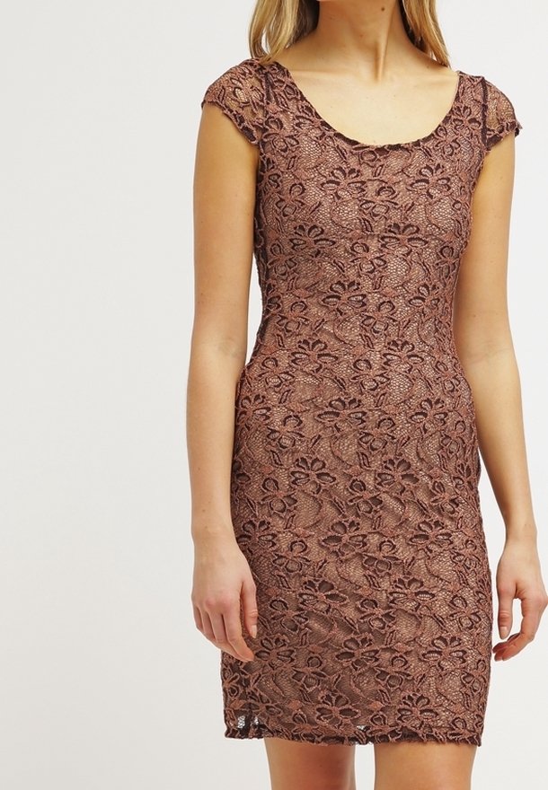 Femme portant une robe en dentelle marron cintrée à manches courtes avec des motifs floraux sur un fond neutre.