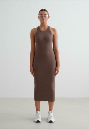 Robe midi marron côtelée avec un design ajusté, sans manches et un col rond, associée à des baskets blanches et des lunettes de soleil teintées de rose.