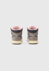 High-top sneakers with a gray suede upper, pink inner lining, contrasting black accents, and a cream rubber sole. Logo on the back.
