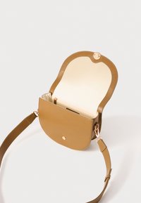 Tan leather crossbody bag with gold clasp, open showing beige interior and inner zippered pocket, set against plain white background.