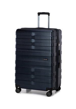 Hard-shell suitcase in dark blue, with a striped texture, silver telescoping handle, and four black wheels for mobility.