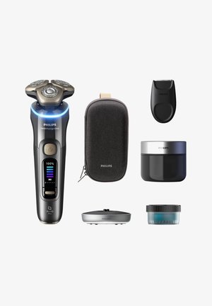Philips I9000 Prestige Ultra elektrisch scheerapparaat in zwart en zilver, inclusief een reisetui, trimmer, twee opbergbakjes en een oplaadstandaard.
