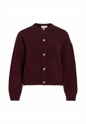 Vīnsarkana adīta kardigana ar apaļu kakla izgriezumu, kastveida piegriezumu un sudraba sirds formas pogām priekšpusē. Mīksta tekstūra, gari piedurkņi.