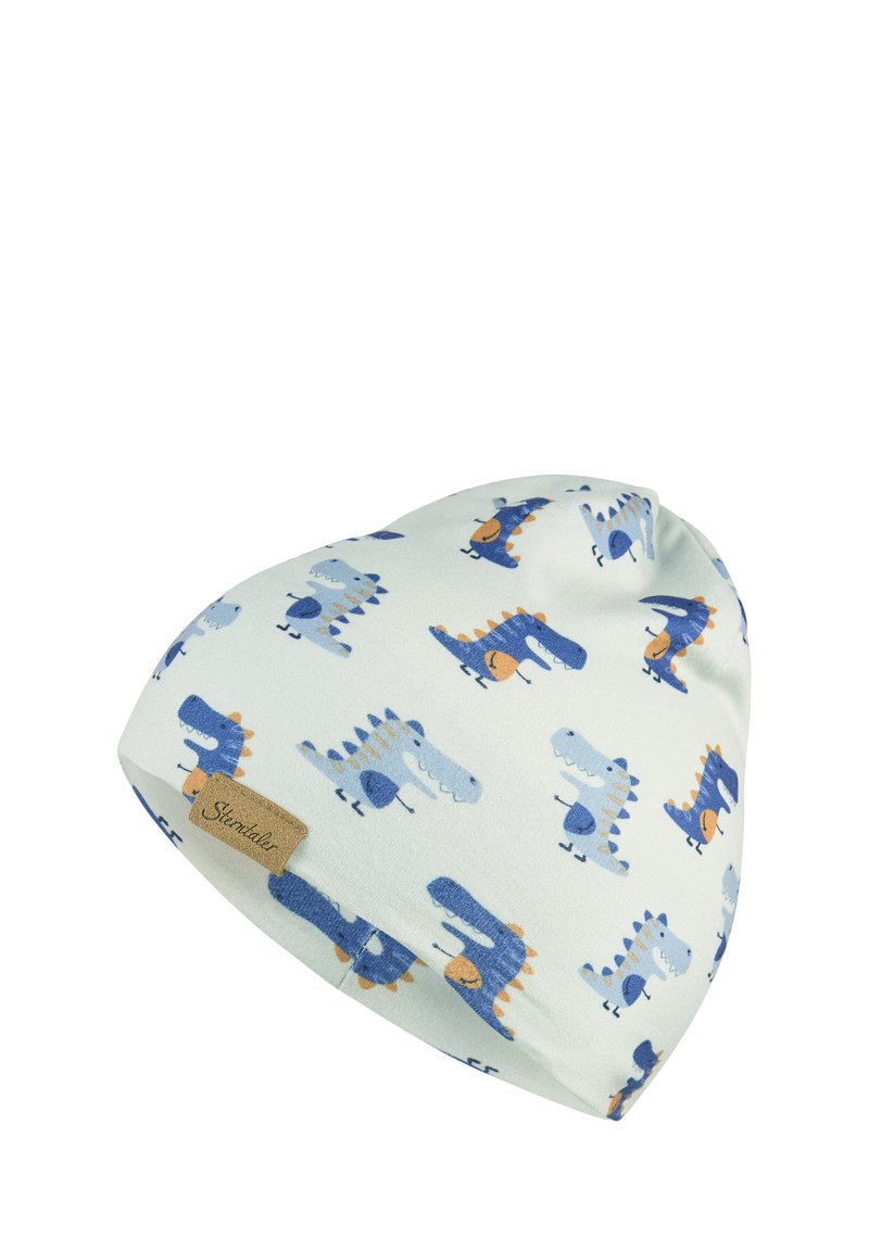 Soft white baby hat with blue and orange cartoon dinosaurs pattern and a small brown fabric tag.
