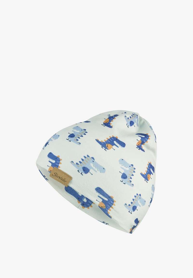 Soft white baby hat with blue and orange cartoon dinosaurs pattern and a small brown fabric tag.