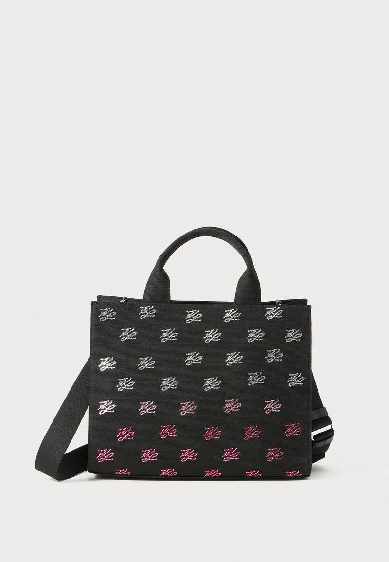 Black rectangular tote bag with short handles and a shoulder strap, decorated with repeating gradient white to pink monogram pattern.