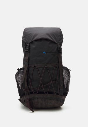 Black backpack with a roll-top closure, elastic cord detail, and mesh side pockets. Features a blue brand logo and sturdy straps.