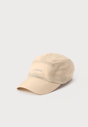 Light beige nylon cap with curved brim and small ventilation perforations on the sides, featuring a subtle "ARKK" logo on the front.
