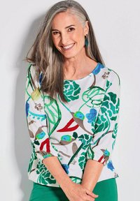 Witte top met bloemenprint, voorzien van groene bladeren en blauwe bloemen. Driekwart mouwen met elastische manchetten. Glad materiaal, ronde halslijn.
