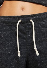 Mörkgrå sweatpants i strukturerat tyg, med en vit dragsko med tofsar och en åtsittande midja.