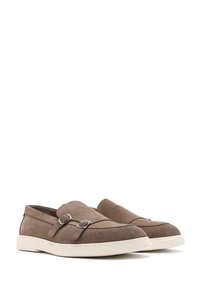 Brown suede slip-on shoes with a white rubber sole, featuring double buckle accents and a smooth, textured surface. Rounded toe design.
