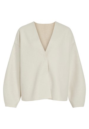 Kreminės spalvos užlenkta megztinis su giliu V formos iškirpimu, laisvu siluetu ir žemomis pečių siūlėmis. Minkšta, tekstūruota medžiaga be matomų užsegimų ar raštų.