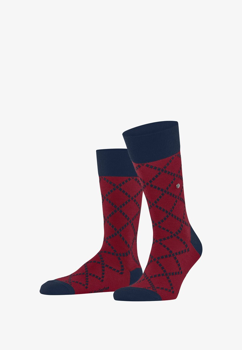 Chaussettes rouges avec un poignet marine, ornées d'un motif en diamant bleu marine et vert. Fabriquées en mélange de coton de poids moyen pour le confort.