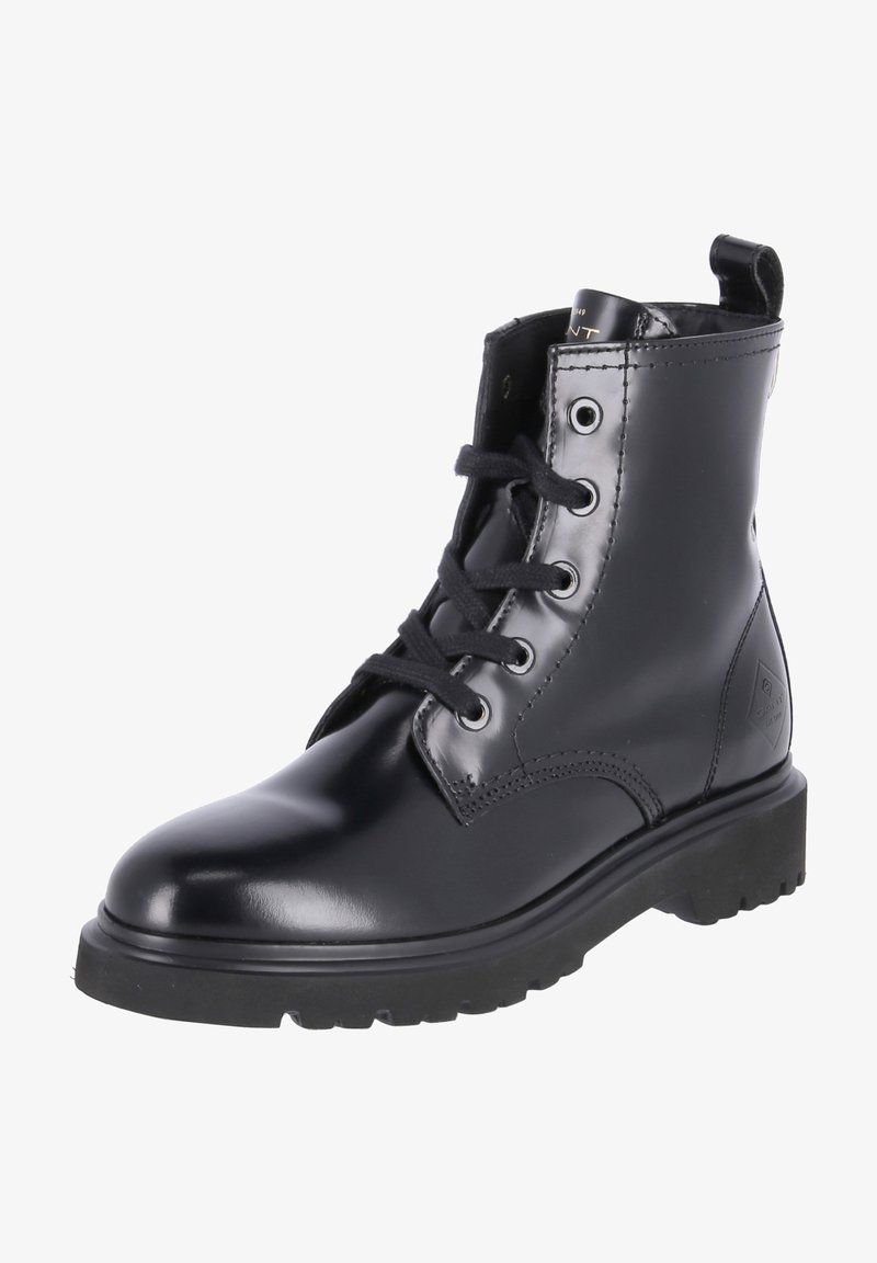 Black ankle boot made of glossy leather, featuring round toe, lace-up design, and sturdy black rubber sole with tread for traction.
