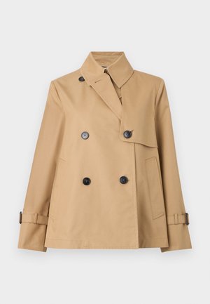 Veste à double boutonnage couleur tan, fabriquée en tissu lisse. Dotée d'un col haut, de boutons noirs et de poignets réglables avec des accents de ceinture.