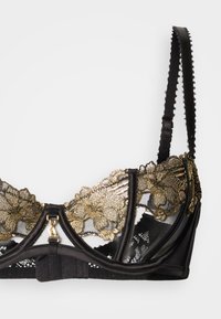 Black lace bra featuring gold floral embroidery, an underwire design, adjustable straps, and a gold hardware front closure.