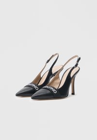 Czarne buty na obcasie typu slingback z wąskim noskiem, ozdobione kontrastującym, drukowanym paskiem. Wykonane ze skóry, o gładkiej fakturze i cienkim szpilkowym obcasie.