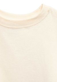Beige crew neck T-shirt with visible stitching around the collar, displayed on a plain white background.