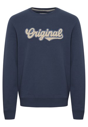 Navy crewneck sweatshirt with ribbed cuffs and hem. Features embroidered “Original” in cream-colored script across the chest. Soft texture.