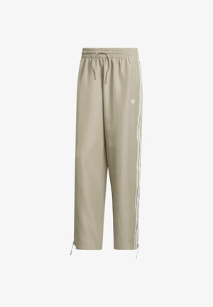 Helle beige, zugeschnittene Jogginghosen mit elastischem Bund, Kordelzug und weißen Seitenstreifen. Verfügt über verstellbare Bündchen und ein Logo-Detail.