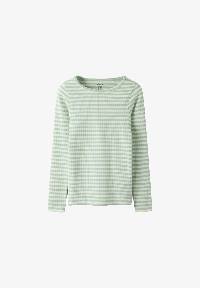 Zielona i biała bluzka w paski z długim rękawem i okrągłym dekoltem. Charakteryzuje się prążkowaną fakturą oraz bocznymi rozcięciami u dołu, zapewniającymi większą swobodę ruchów.