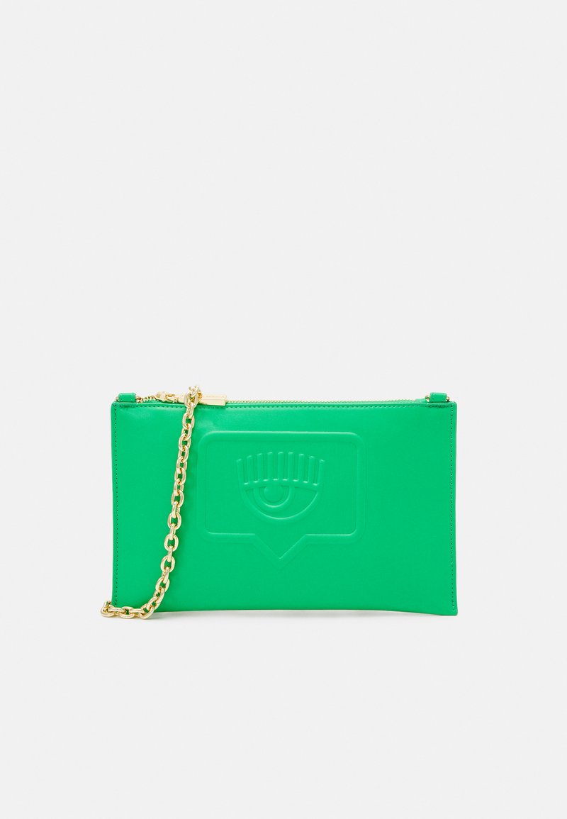 Green leather clutch with embossed eye design, gold chain strap, zip closure, rectangular shape, smooth texture, minimal detailing.