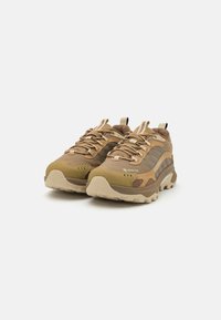 Tan hiking shoes with mesh and leather upper, patterned accents, rugged sole, and lace-up design. Features GORE-TEX for waterproofing.