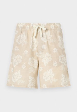 Beige floral shorts made of lightweight fabric, featuring a drawstring waistband and a relaxed fit with white floral patterns.