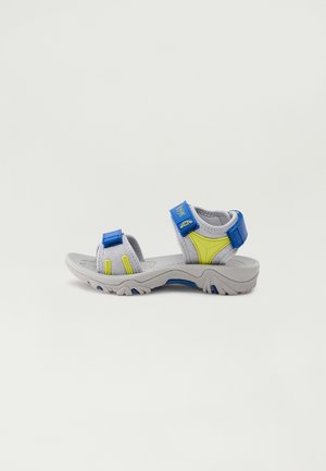 Gray outdoor sandals with yellow and blue accents. Adjustable straps and textured sole designed for traction. Lightweight synthetic material.