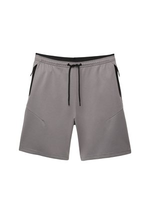 Shorts atletici grigi realizzati in materiale elastico, con un laccio nero, due tasche laterali con zip e una texture liscia.