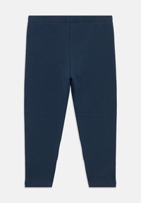 Σκούρο μπλε βαμβακερό κολάν με ομαλή υφή, ελαστική μέση και εφαρμοστή σχεδίαση, που φτάνει μέχρι τους αστραγάλους χωρίς εμφανή ραφές.