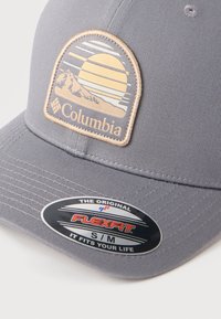 Γκρι καπέλο μπέιζμπολ Columbia με έμπλαστρο βουνό και ήλιο, αυτοκόλλητο Flexfit μέγεθος S/M στη λυγισμένη γείσο.