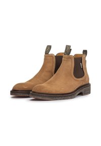 Paire de bottines Chelsea en daim beige avec panneaux latéraux élastiques noirs et languettes de traction, semelles empilées marron, inclinées vers la droite sur fond blanc.