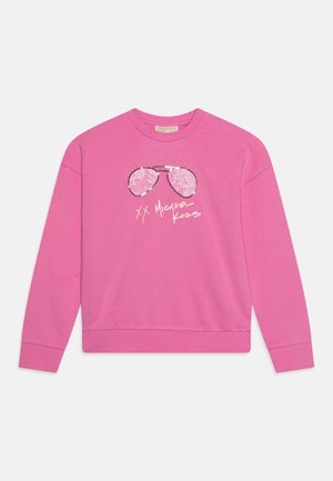 Sudadera rosa con un gráfico de gafas de sol con un patrón floral y el texto "XX Michael Kors" abajo. Tejido suave, corte relajado.