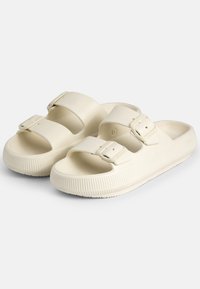 Sandali scivolosi beige chiaro in gomma, con due cinturini regolabili dotati di fibbie, soletta texturizzata e suola scanalata per una migliore aderenza.