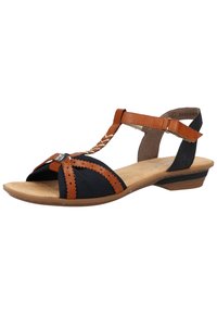 Tan and navy blue sandal with open toe, T-strap design, textured fabric, stitched accents, and low heel. Includes decorative detailing.