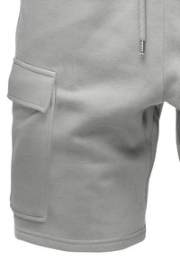 Helle graue Shorts aus weichem Material, mit einer Seitentasche und gesticktem Saum. Das Design ist lässig mit einer lockeren Passform.