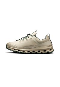 Hellebeige Sportschuh mit strukturiertem Obermaterial, grünen Akzenten, flexibler Sohle und aerodynamischem Design. Verfügt über ein Schnürsystem für einen sicheren Sitz.