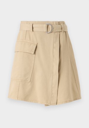 Beige cotton skirt with a side pocket, belted waist featuring a silver ring, and a slight A-line shape. Smooth texture and simple design.