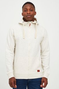 Svijetlosmeđa zip-up hoodie sa prednjim džepom i kapuljačom na vezanje, s smešnim kožnim pečatom na rubu i rebrastim manžetama.