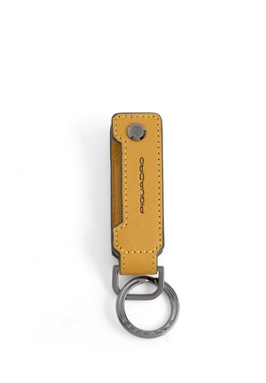 Yellow leather keychain with black stitching, metal ring, and Piquadro logo printed vertically on the leather strap.