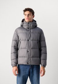 Gray puffer jacket with a high collar and adjustable hood. Features a quilted pattern, front snap buttons, and side zip pockets.