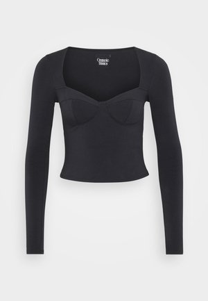 Black, long-sleeved top made from smooth fabric, featuring a fitted design with a sweetheart neckline and seam detailing across the bust.